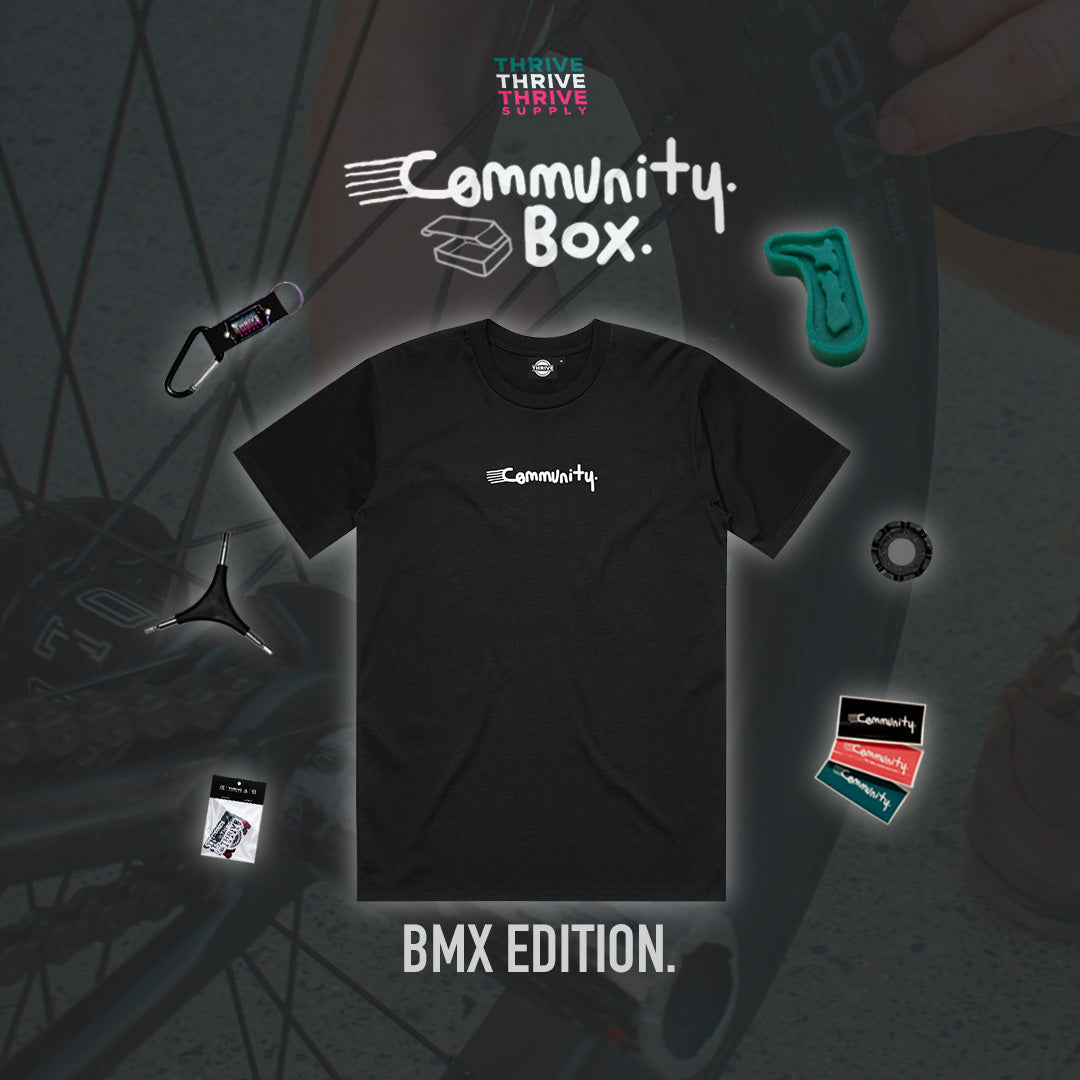 Black t-shirt with 'Community' logo on a dark background with BMX elements.