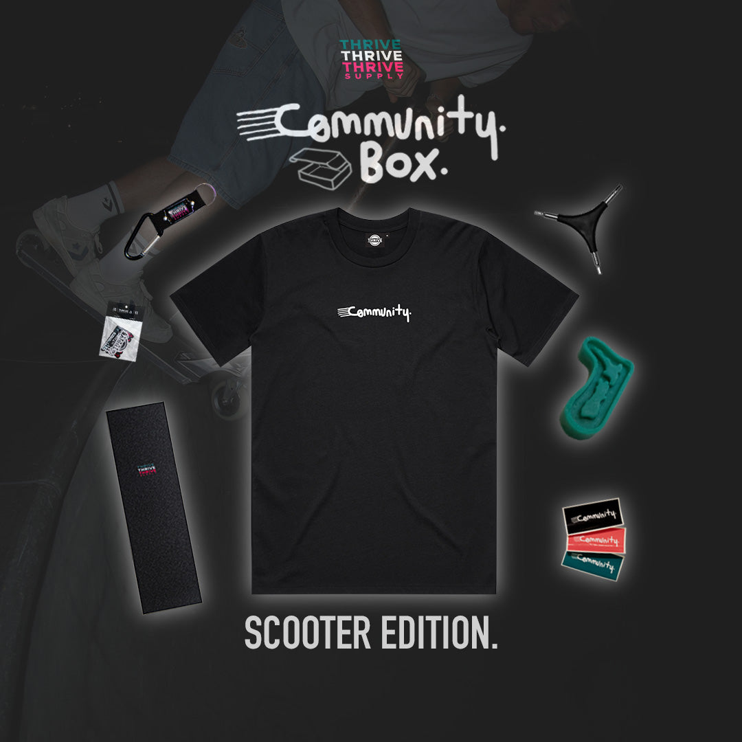 Black t-shirt with 'Community' logo and scooter-themed accessories on a dark background
