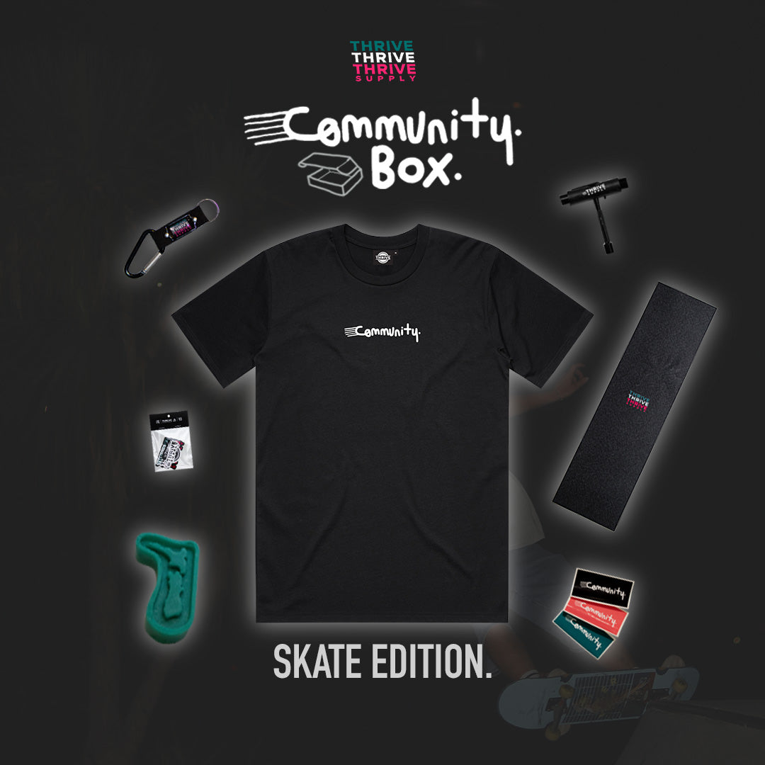 Black t-shirt with 'Community' logo and various items on a dark background