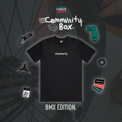 Black t-shirt with 'Community' logo on a dark background with BMX elements.