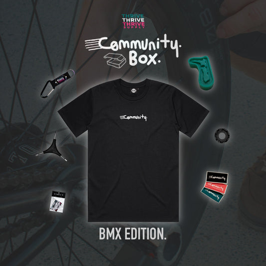Black t-shirt with 'Community' logo on a dark background with BMX elements.