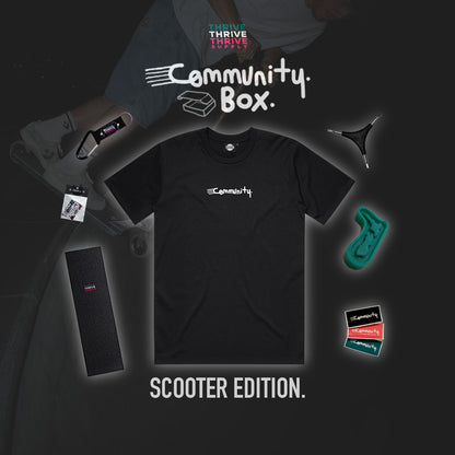 Black t-shirt with 'Community' logo and scooter-themed accessories on a dark background