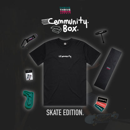 Black t-shirt with 'Community' logo and various items on a dark background